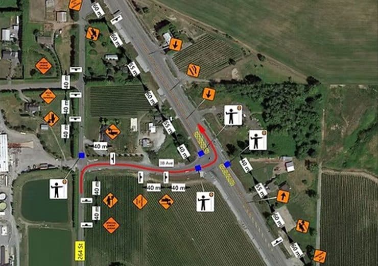An aerial view of an intersection overlaid with a traffic management plan: signage positions, device spacing in metres, flagger stations and the marked detour route.